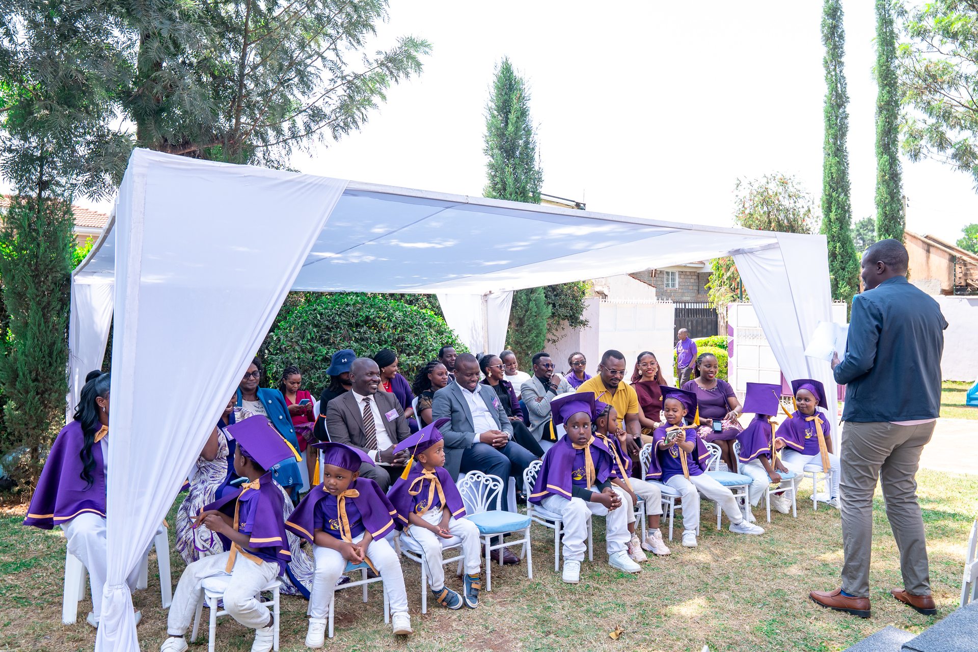 Proud families seated under the celebration tent at Jofad graduation day