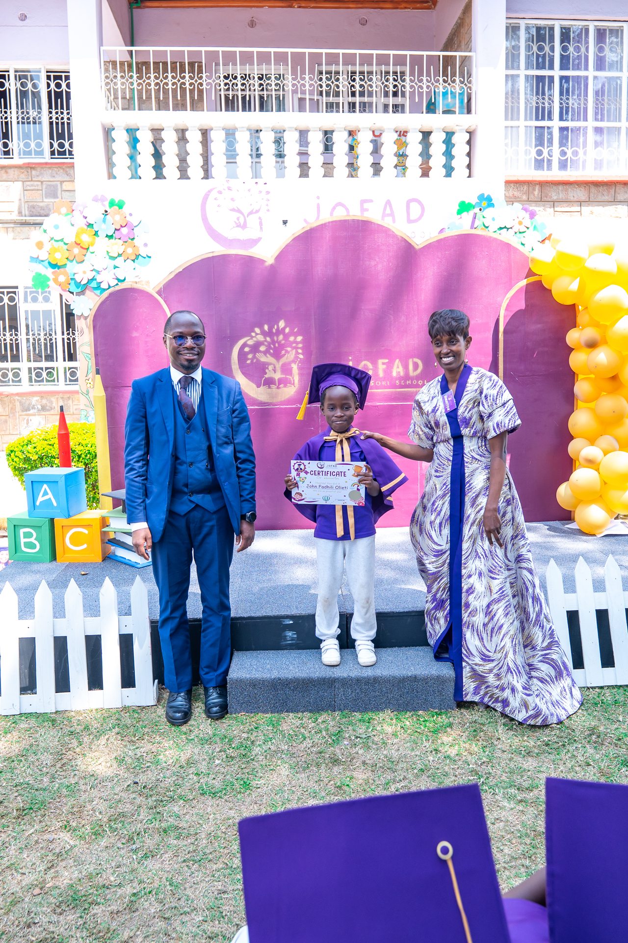 Jofad graduate and family with certificate — a moment of pride