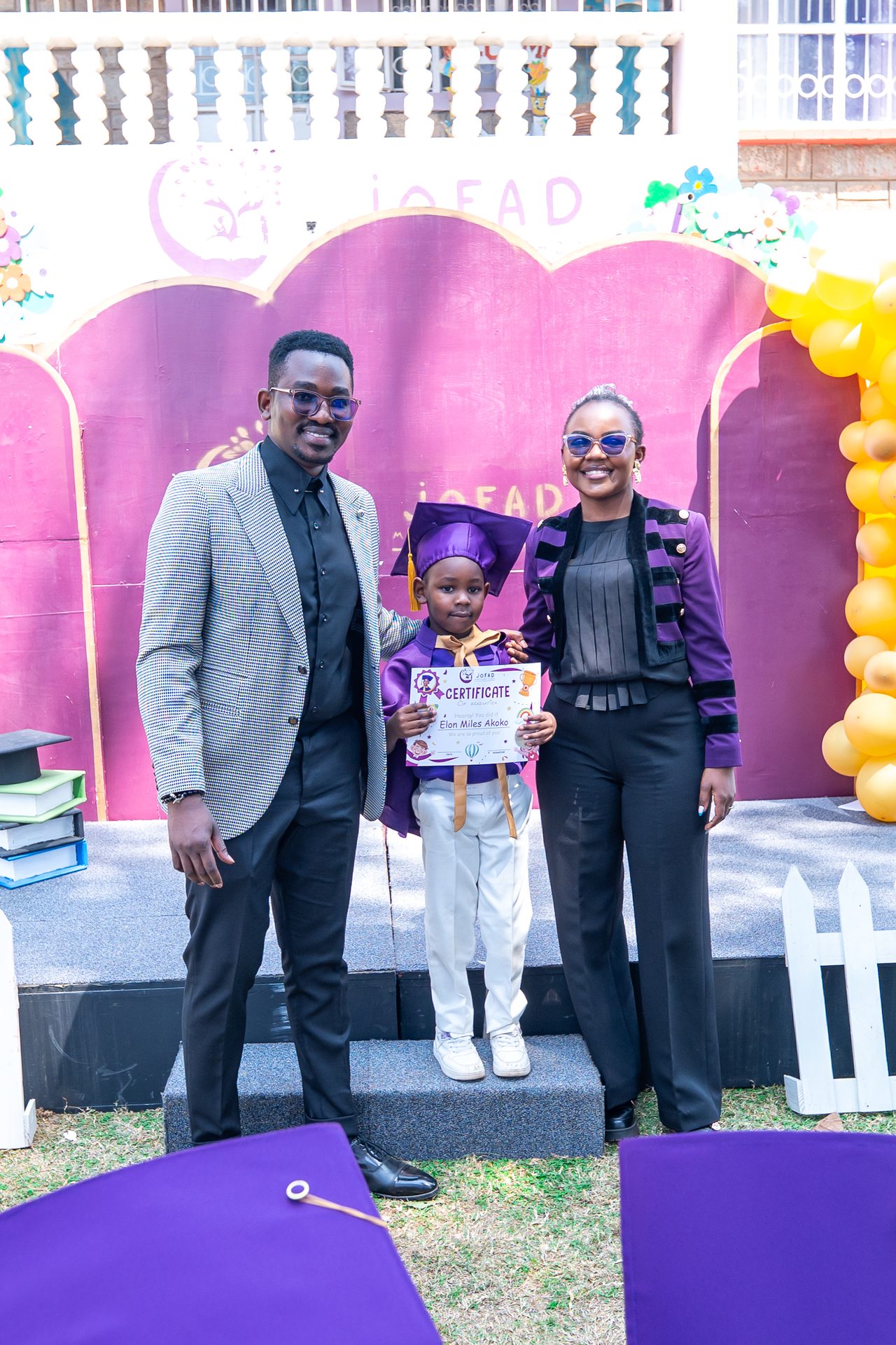 Graduate and family portrait at Jofad year-end ceremony