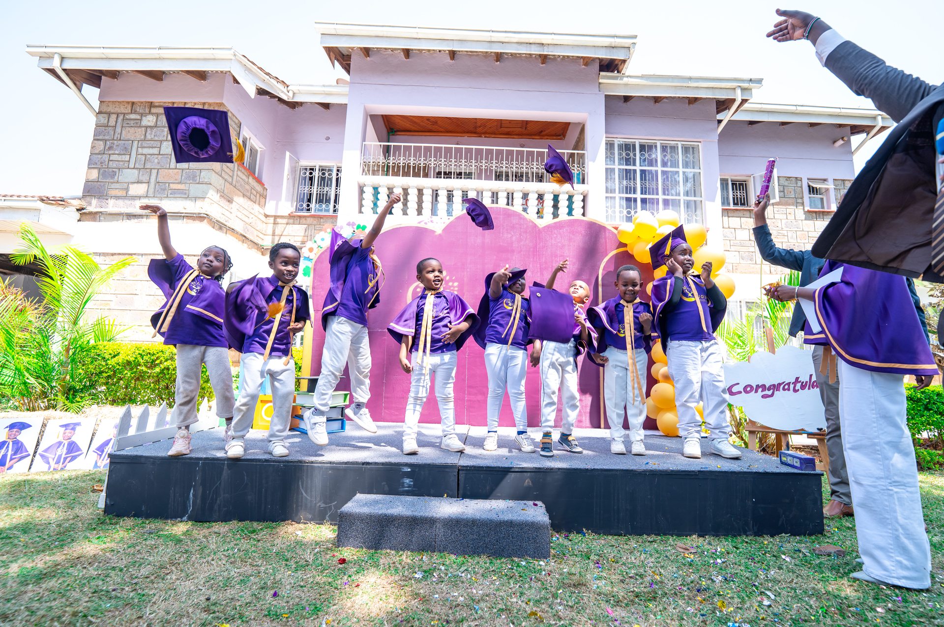 Jofad graduates tossing caps in celebration